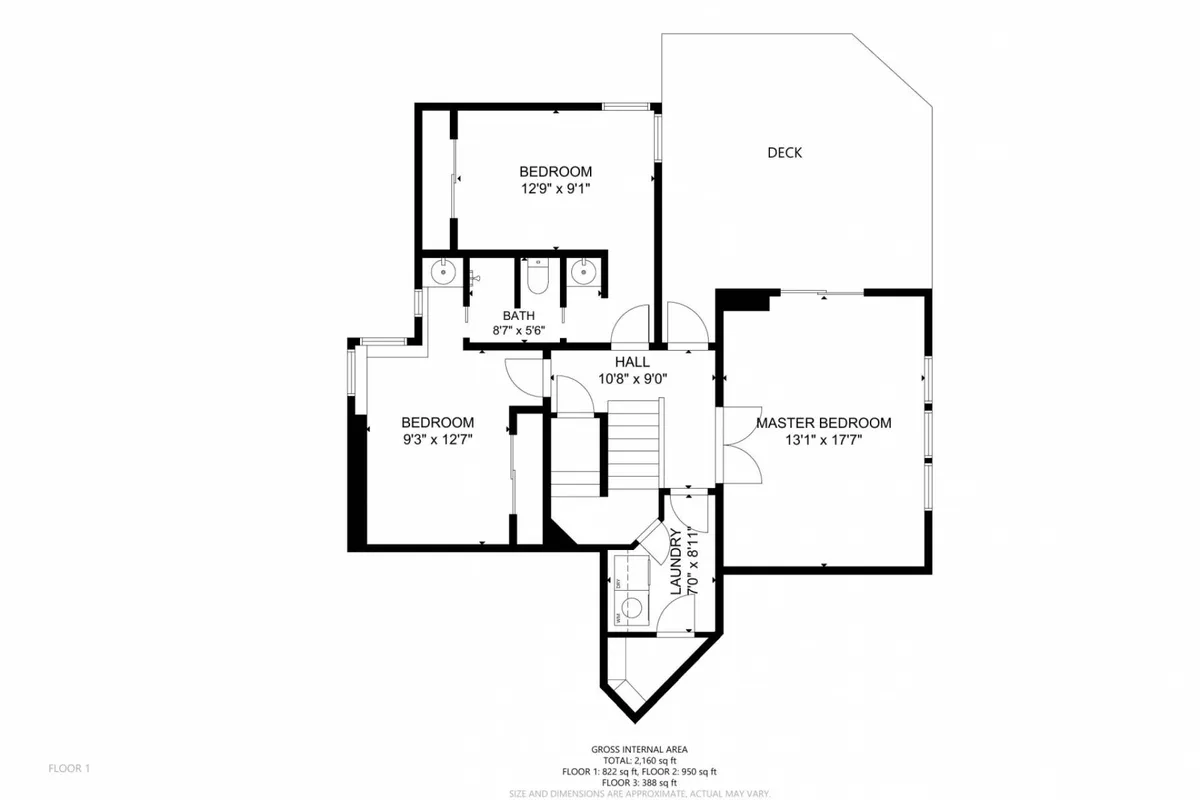 A spacious master bedroom with a large bed, deck access, and a visible laundry area. The room exudes warmth and practicality, offering views to the deck and enough space for relaxing and daily routines.